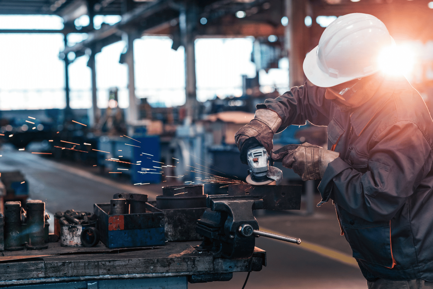 Angle Grinder being used to shape metal workpiece.