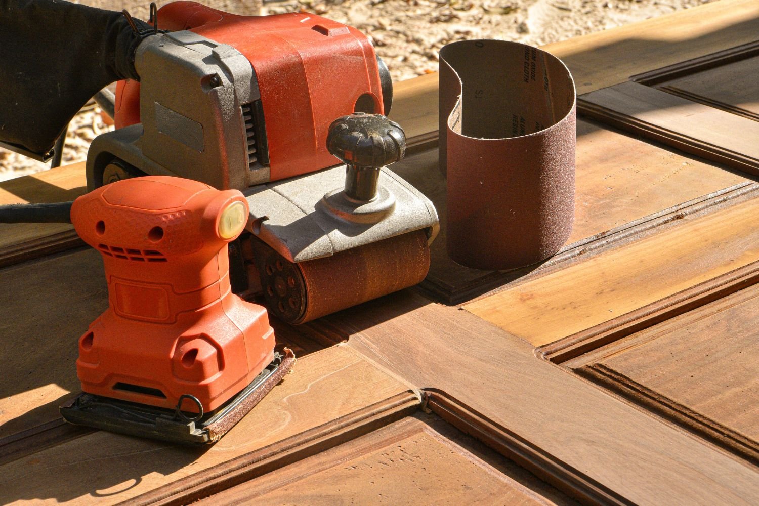 The belt sander's trigger takes you to maximum speed for leveling and smoothing rough boards.