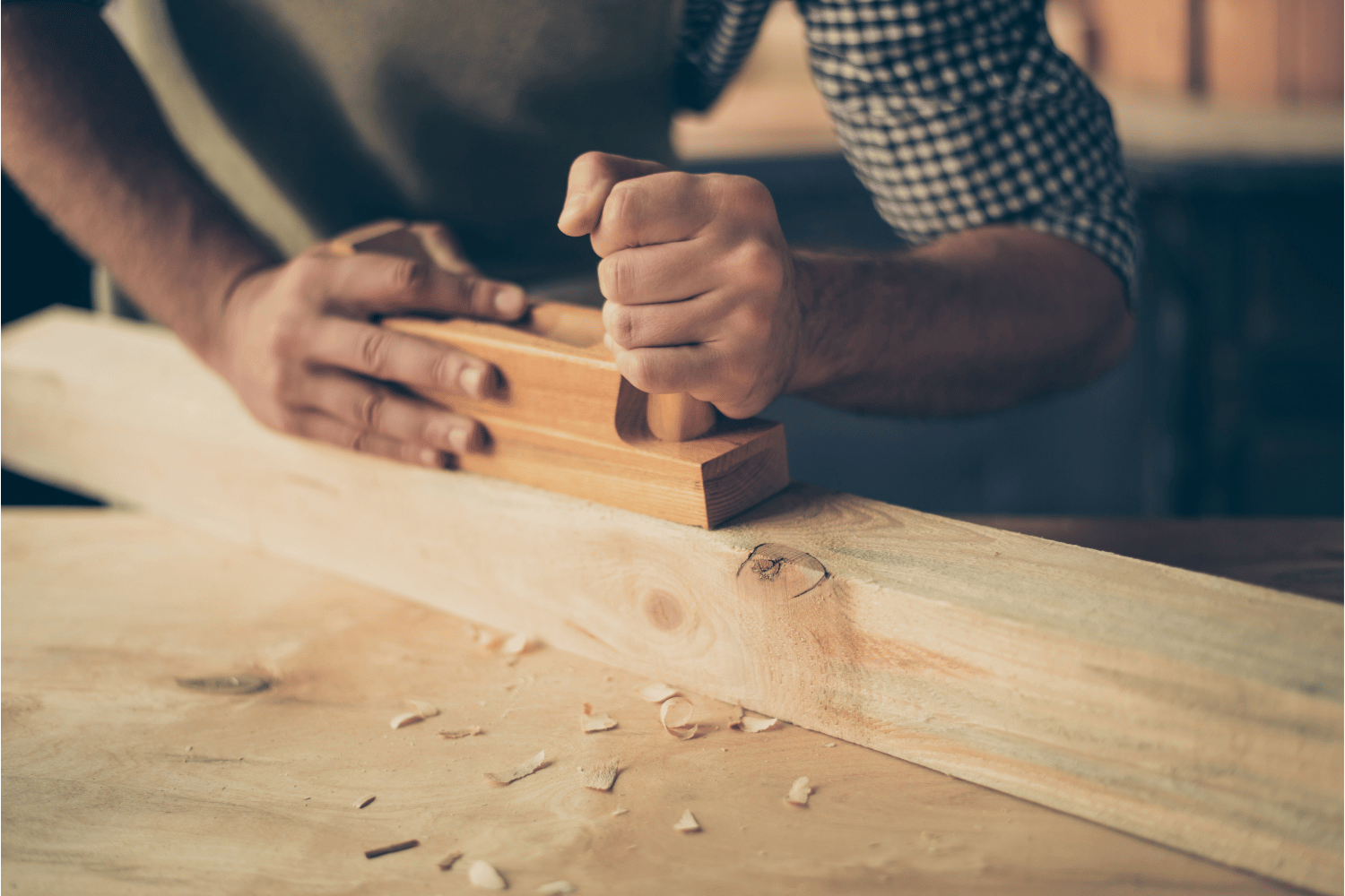 A person using a hand plane to edge joint two pieces of wood