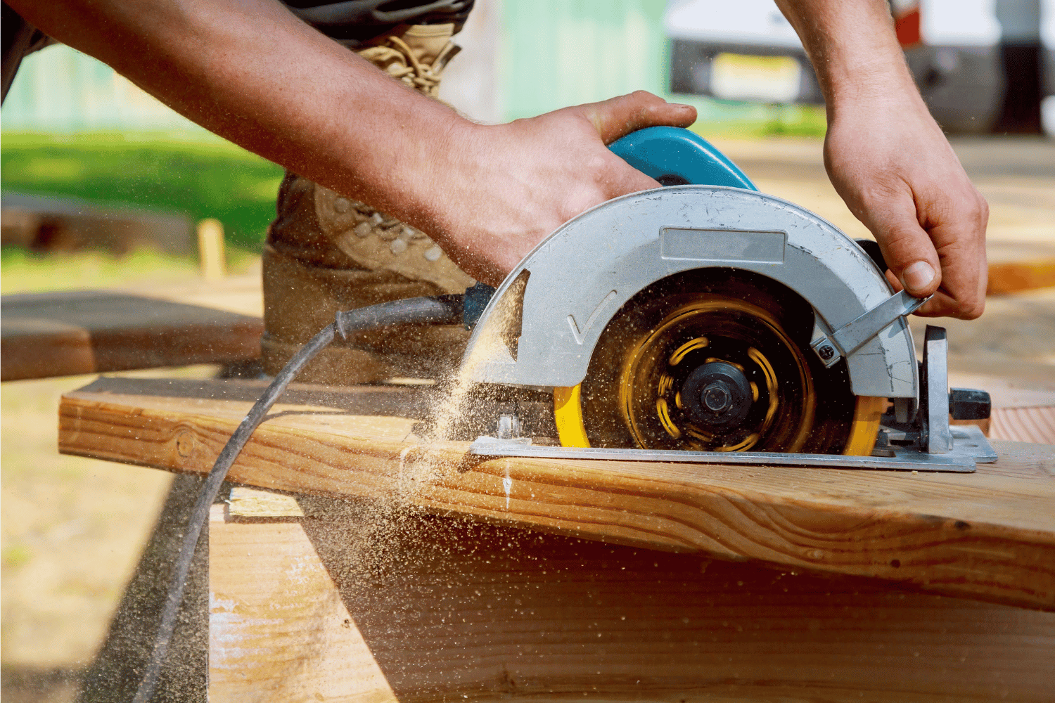 Circular Saw cutting blade through a wood board