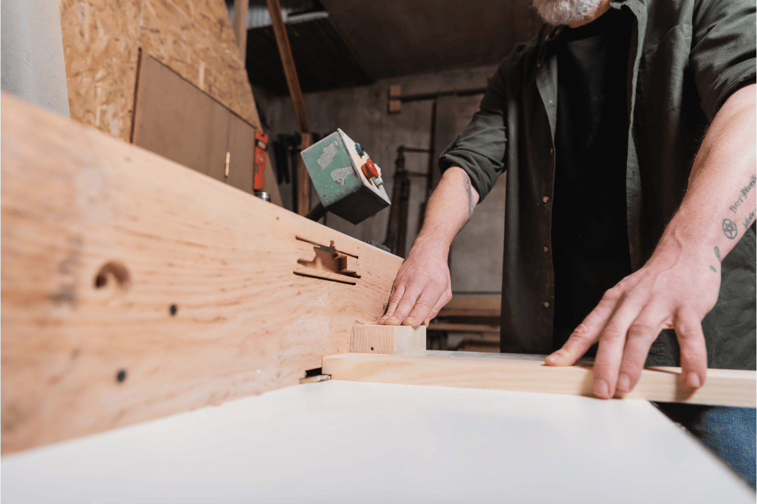 A person using a power tool to rabbet with a jointer