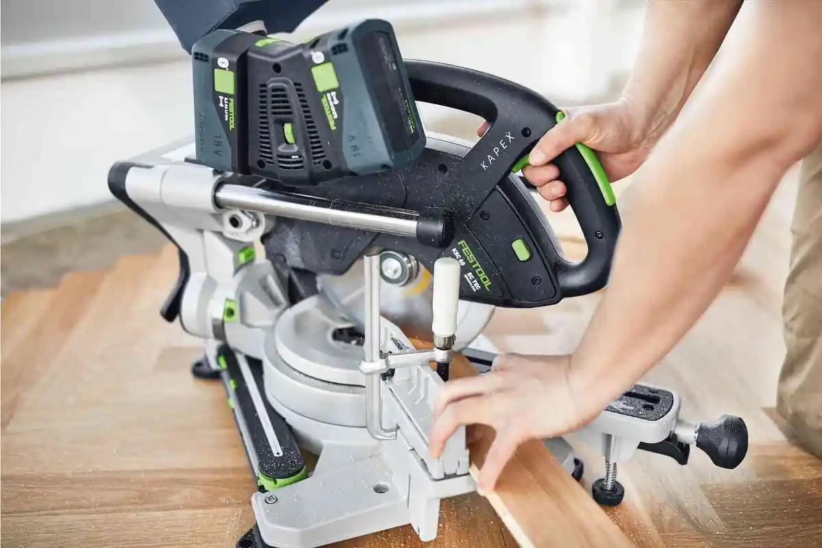 Festool Miter Saw making a miter cut on flooring.