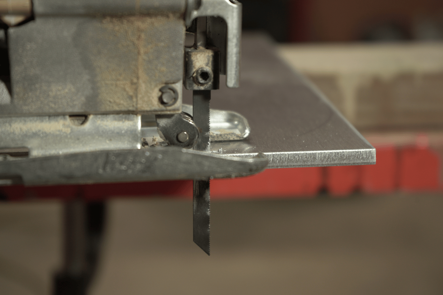 A jigsaw making cuts in metal
