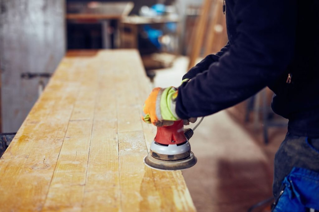 Sand in overlapping patterns to achieve a superior finish. You don't even have to turn the sander.