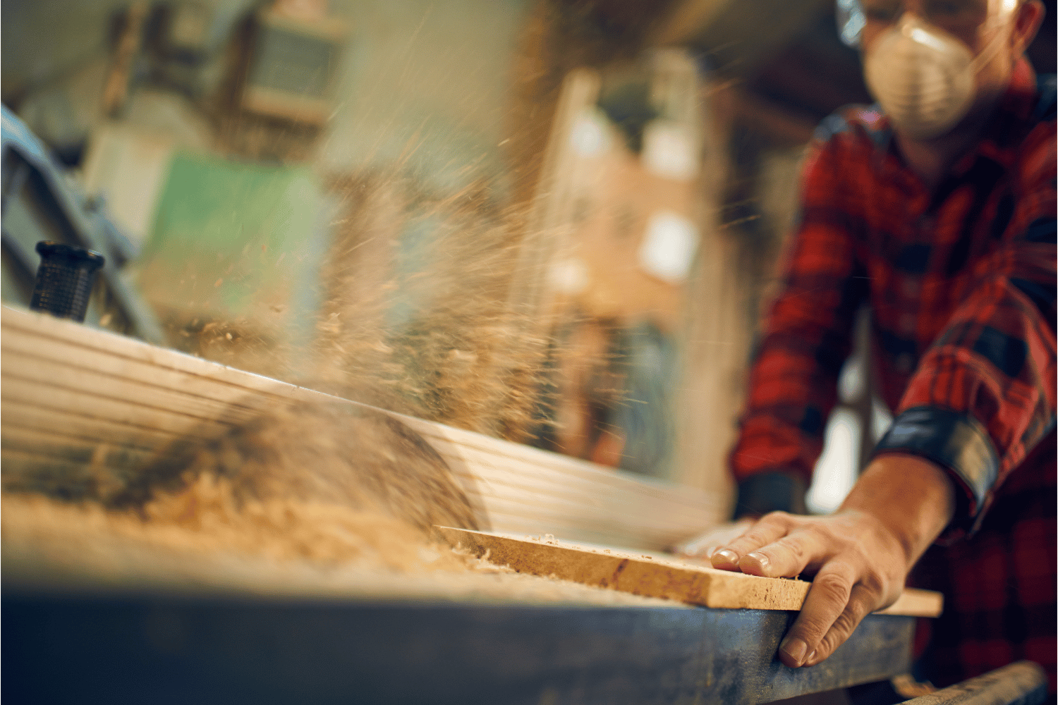 A person using a table saw to cut wood