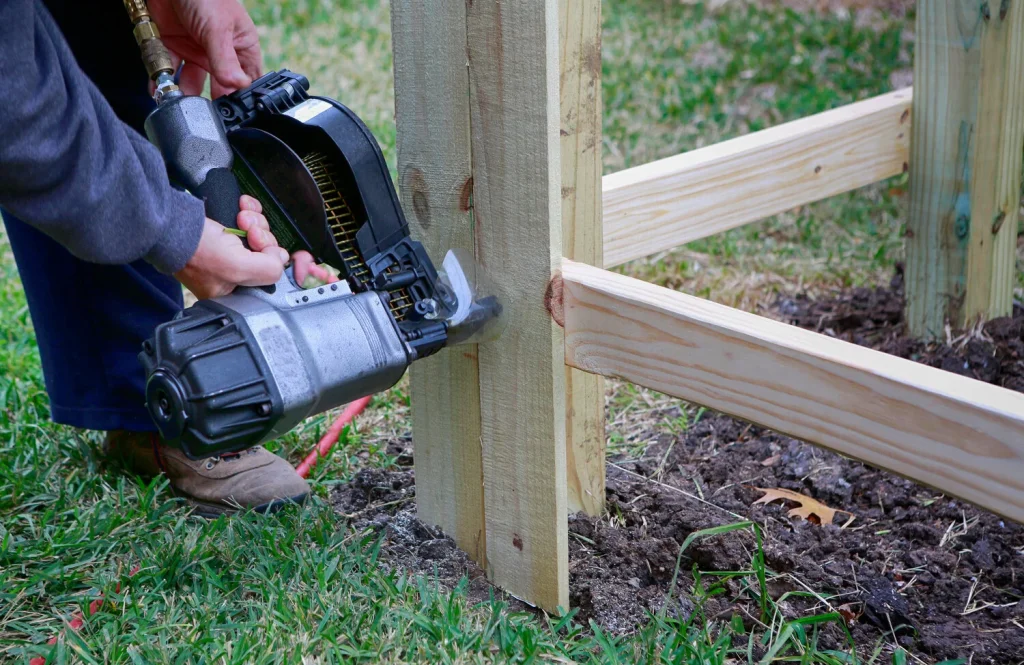 Fully loaded nail gun installing fencing