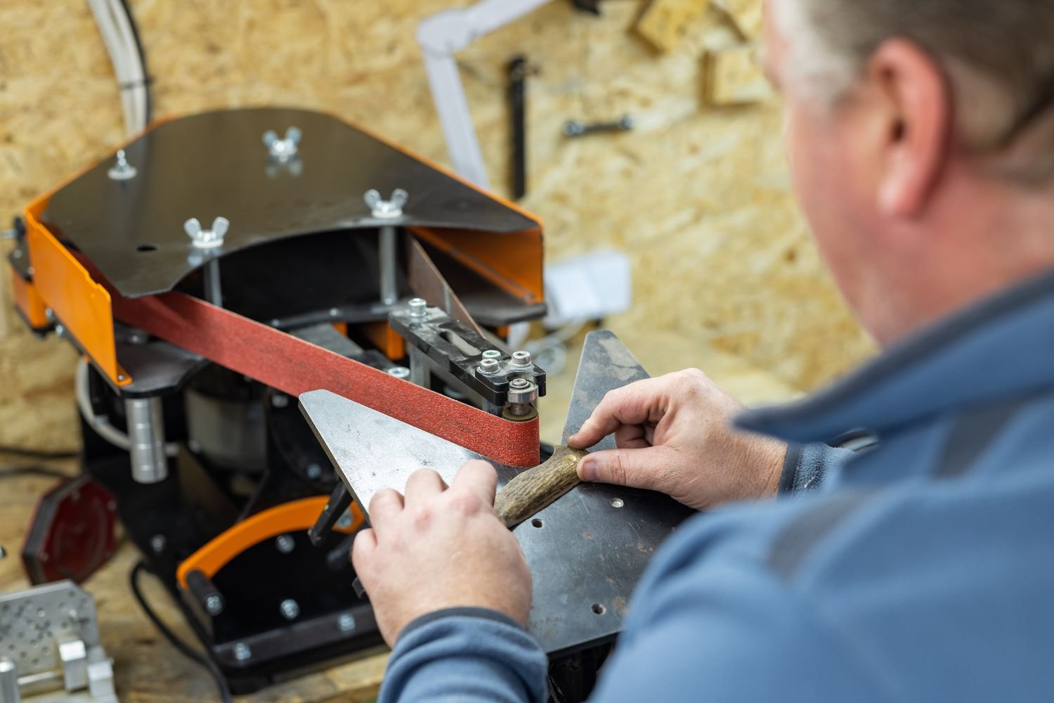 Using a small benchtop belt sander to restore a knife handle