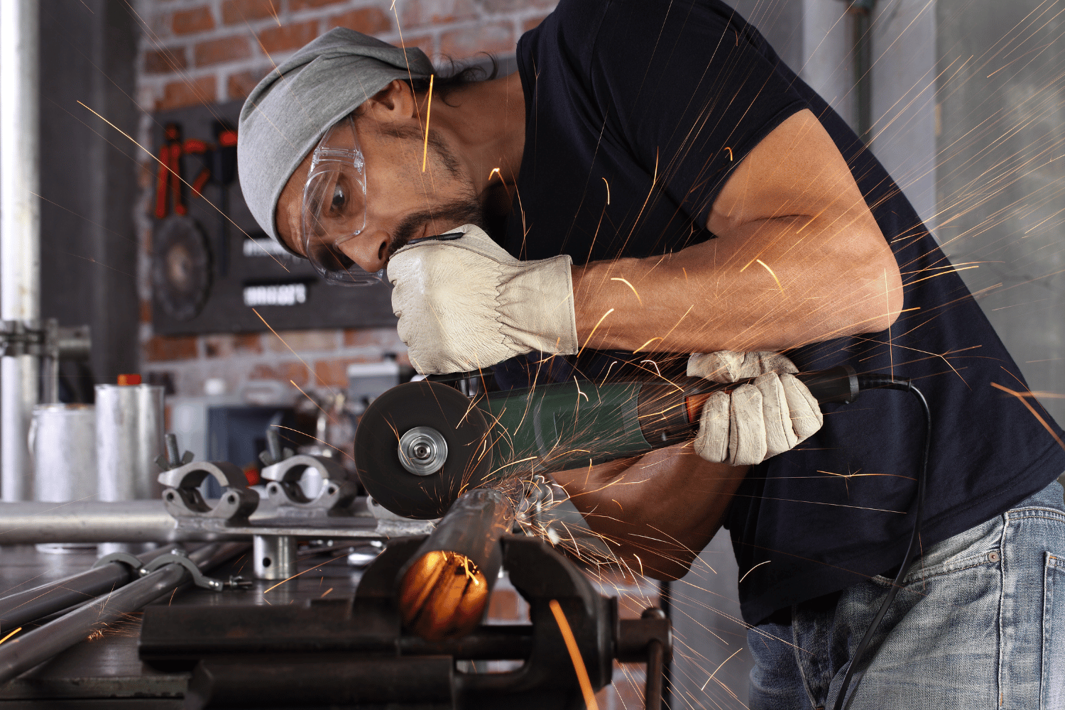 Using an angle grinder to cut metal pipe with a cut off wheel.